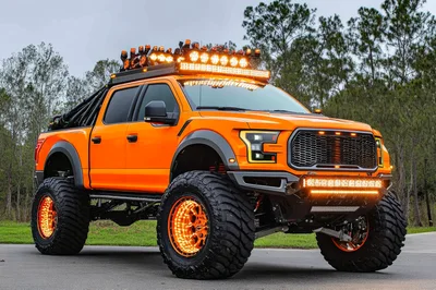 Custom Lifted Orange Ford Raptor Off-Road Truck