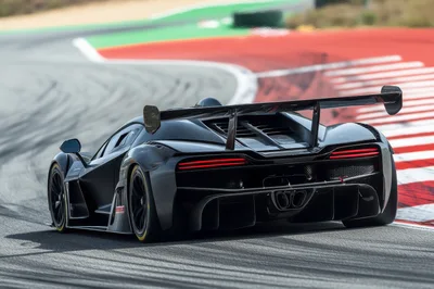 Black Supercar Cornering On A Professional Race Track