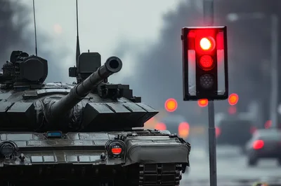 Military Tank Stopped at a Red Traffic Light