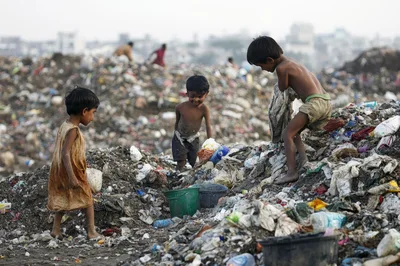 Children Scavenging Through Trash In A Landfill