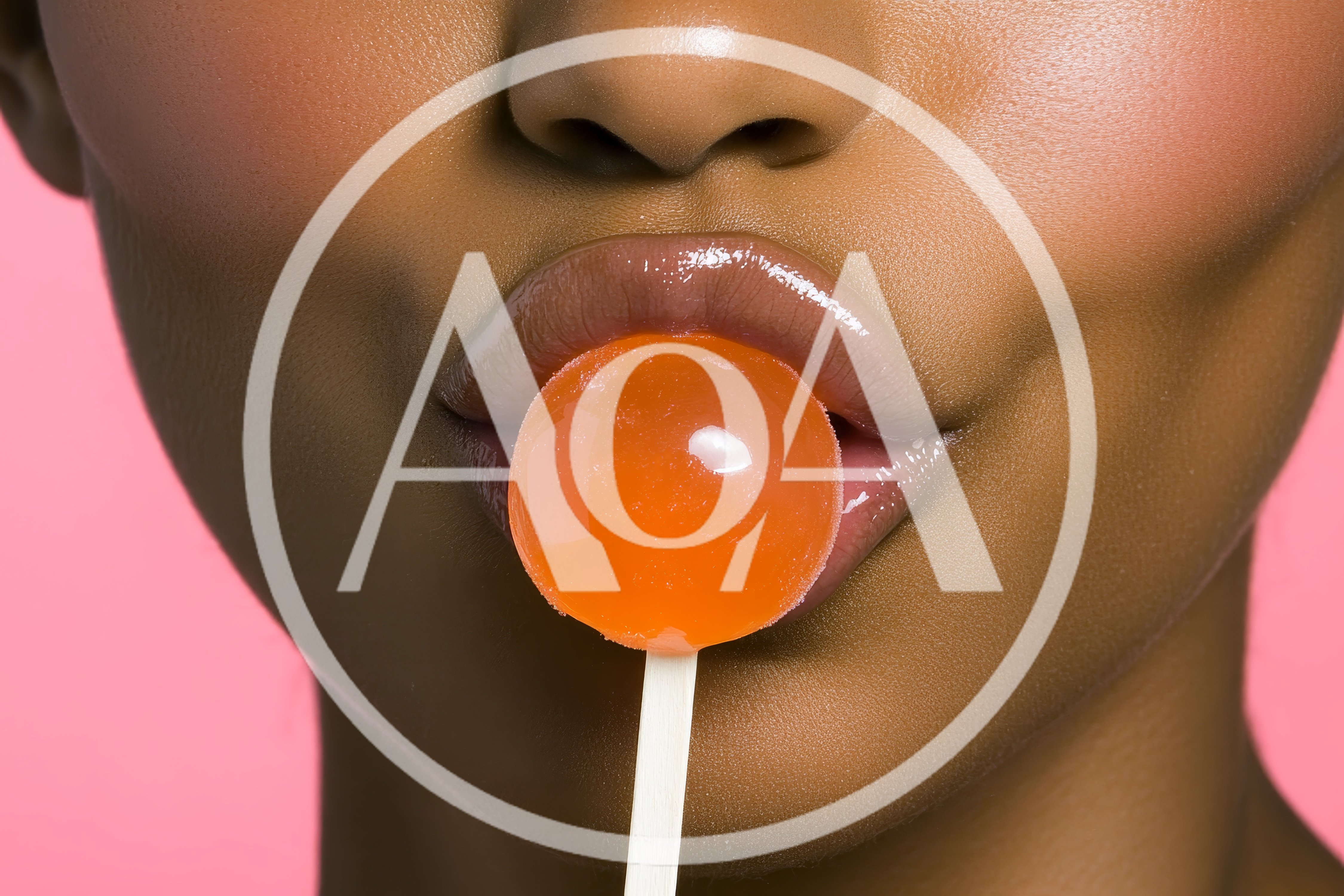 Close Up Of Woman Holding Orange Lollipop