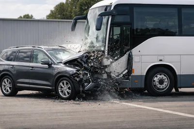 Car Crashing Into A Large Passenger Bus