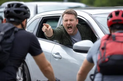 Angry Driver Confronting Cyclists on Road