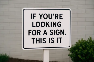 Signage With Humorous Text Against A Brick Wall