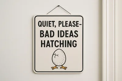 Humorous Sign Hanging On A Plain White Wall