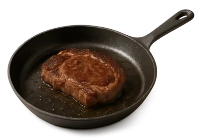 Seared Ribeye Steak Cooking In A Cast Iron Skillet