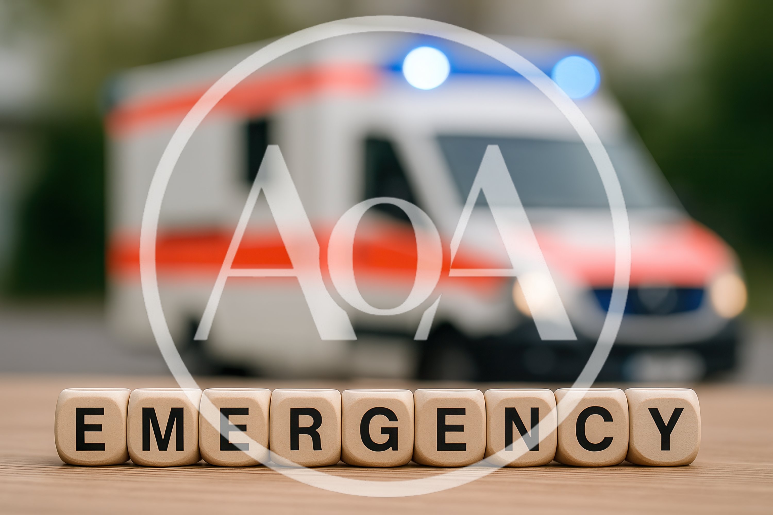 Wooden Blocks Spelling Emergency With Blurred Ambulance Background