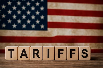 Wooden Blocks Spelling Tariffs Against American Flag Background