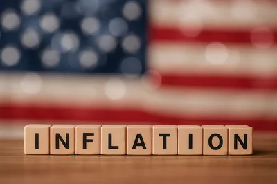 Wooden Blocks Spelling Inflation Against American Flag Background