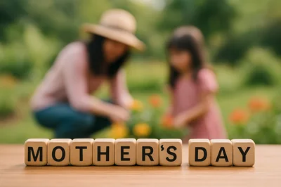 Wooden Blocks Spelling Mothers Day With Blurred Mother And Daughter