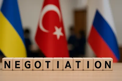 Wooden Blocks Spelling Negotiation With National Flags Background