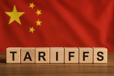 Wooden Blocks Spelling Tariffs Against Chinese Flag Background