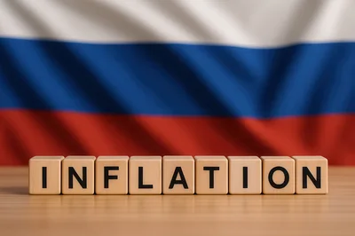 Wooden Blocks Spelling Inflation In Front Of Russian Flag