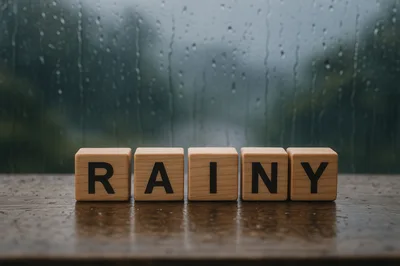 Wooden Blocks Spelling Rainy On A Wet Surface