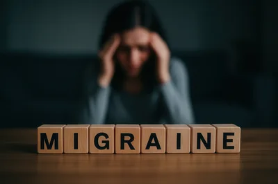Woman Suffering From Migraine With Wooden Blocks