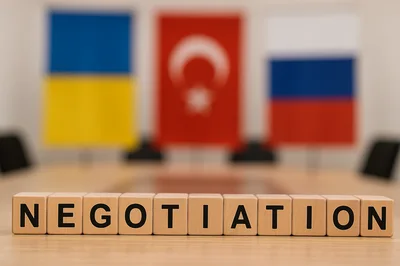 Wooden Blocks Spelling Negotiation With National Flags Background