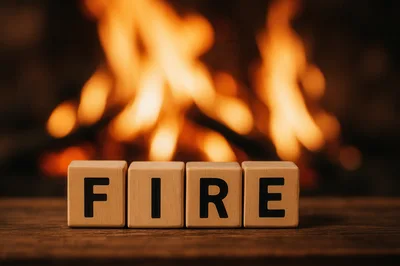 Wooden Blocks Spelling Fire In Front Of A Fireplace