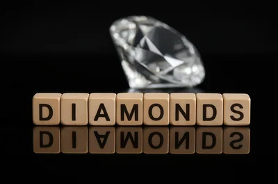 Wooden Letter Blocks Spelling Diamonds With A Gemstone