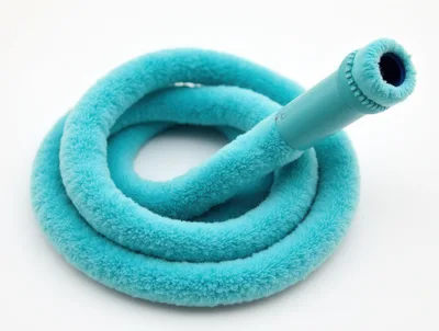 Coiled Turquoise Fuzzy Garden Hose On White Background