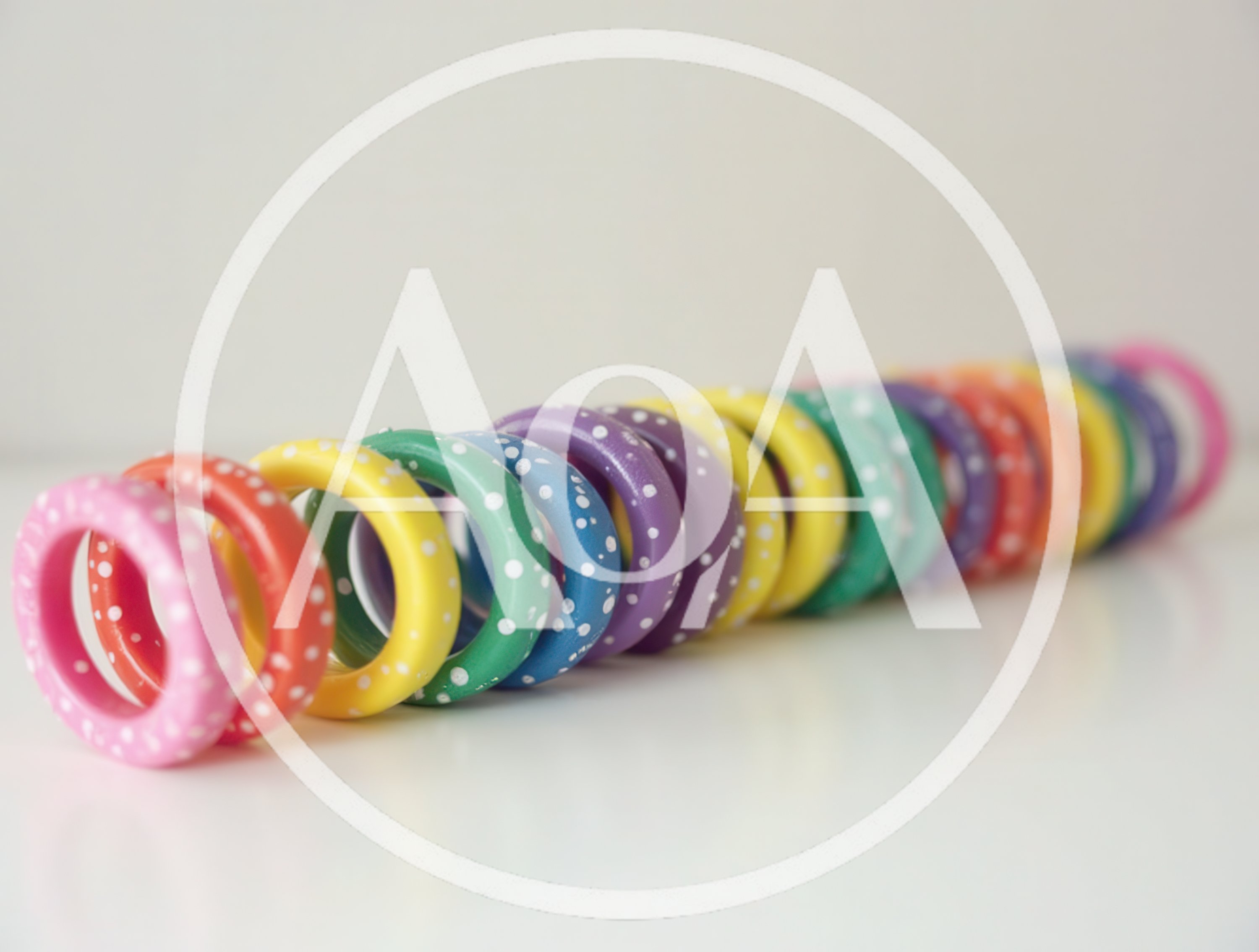 Row Of Colorful Polka Dot Wooden Rings