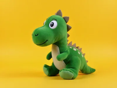 Green Dinosaur Plush Toy On Yellow Background
