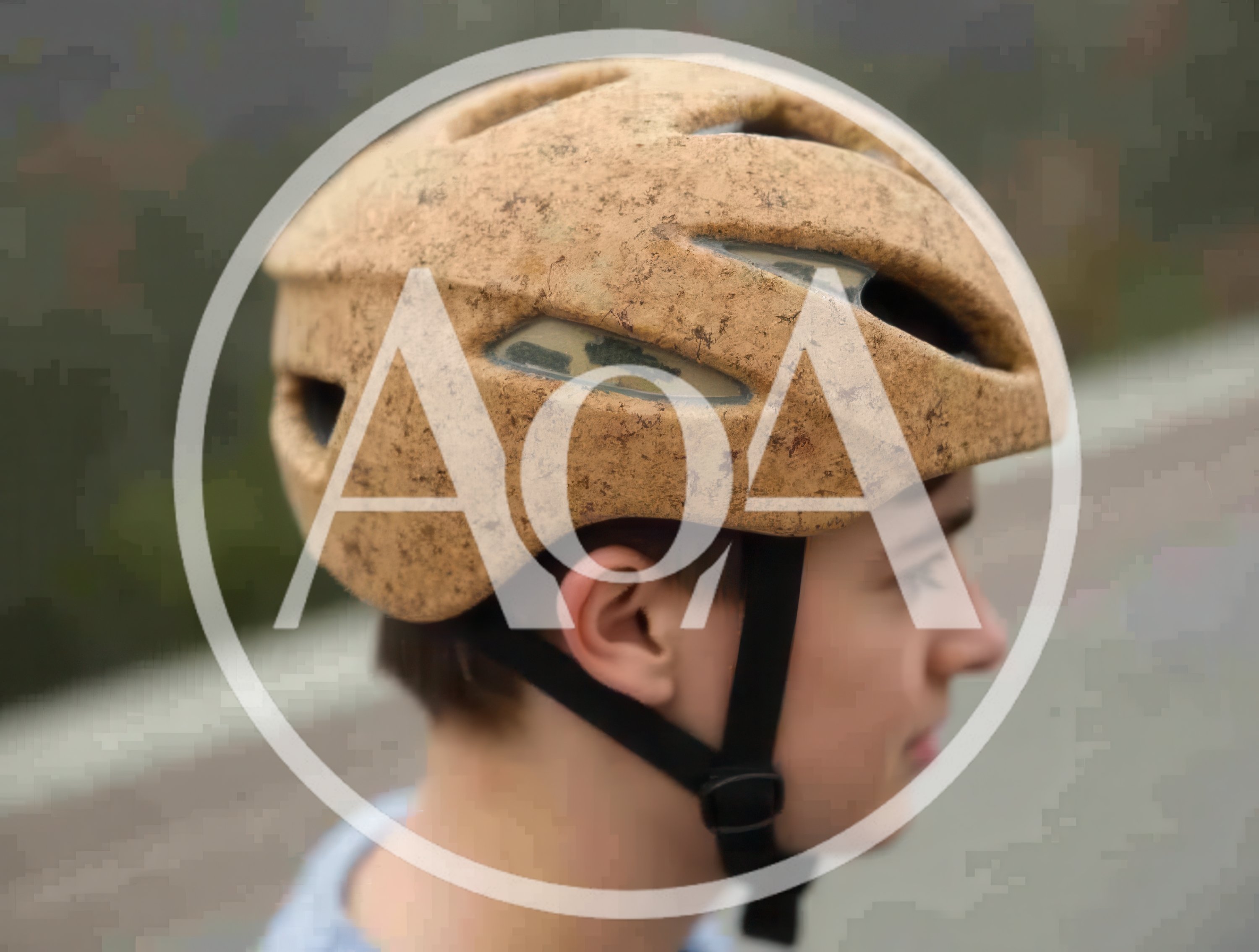 Young Boy Wearing A Textured Cork Bicycle Helmet