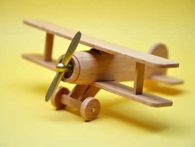 Wooden Biplane Toy On Yellow Background