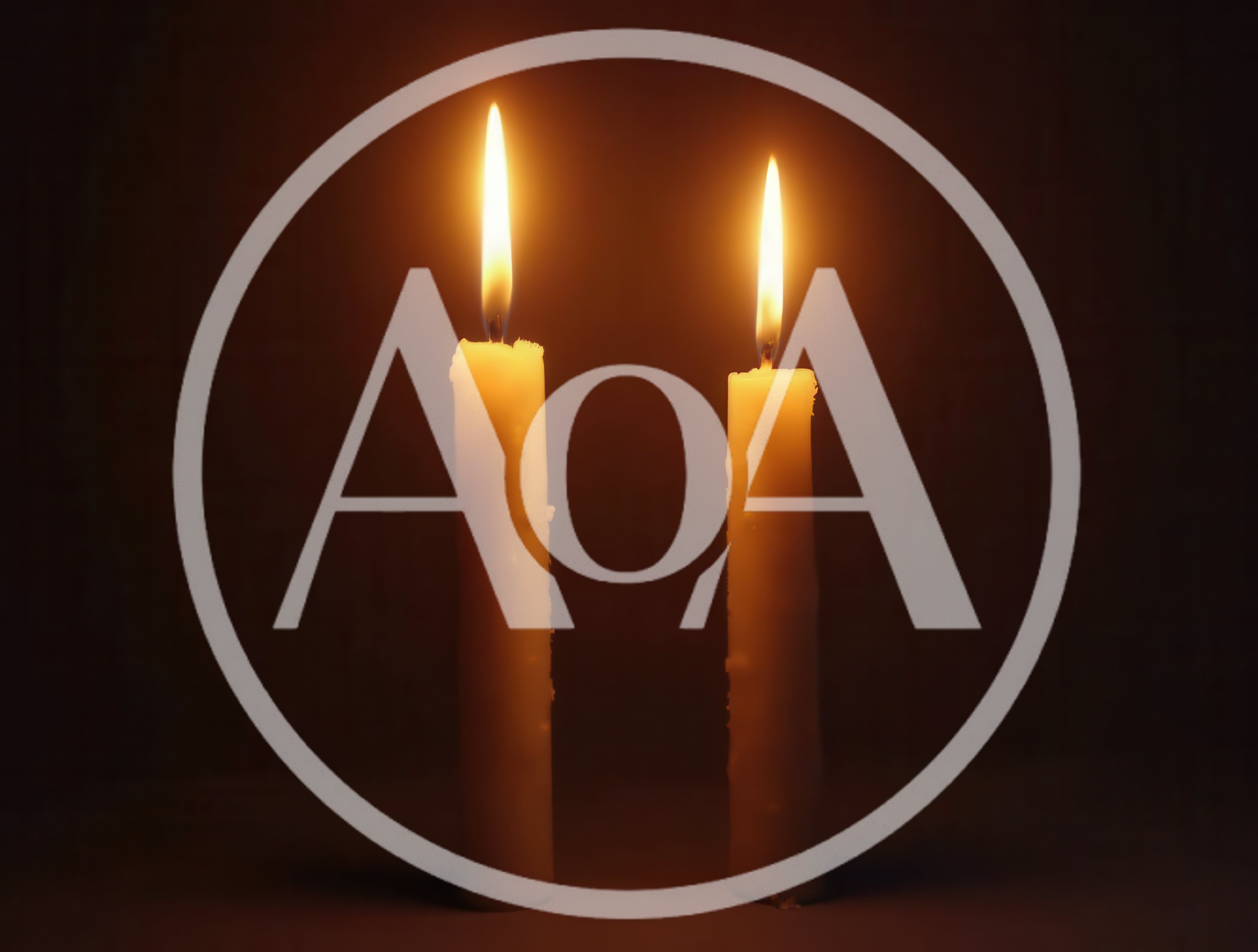 Two Lit Candles Burning In The Dark