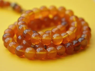 Amber Prayer Beads On A Yellow Background
