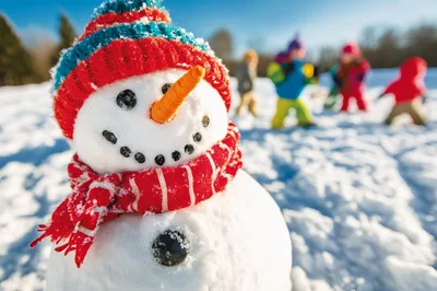 Close Up Of A Snowman With Children Playing