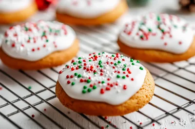 Freshly Baked Christmas Cookies With White Icing And Sprinkles