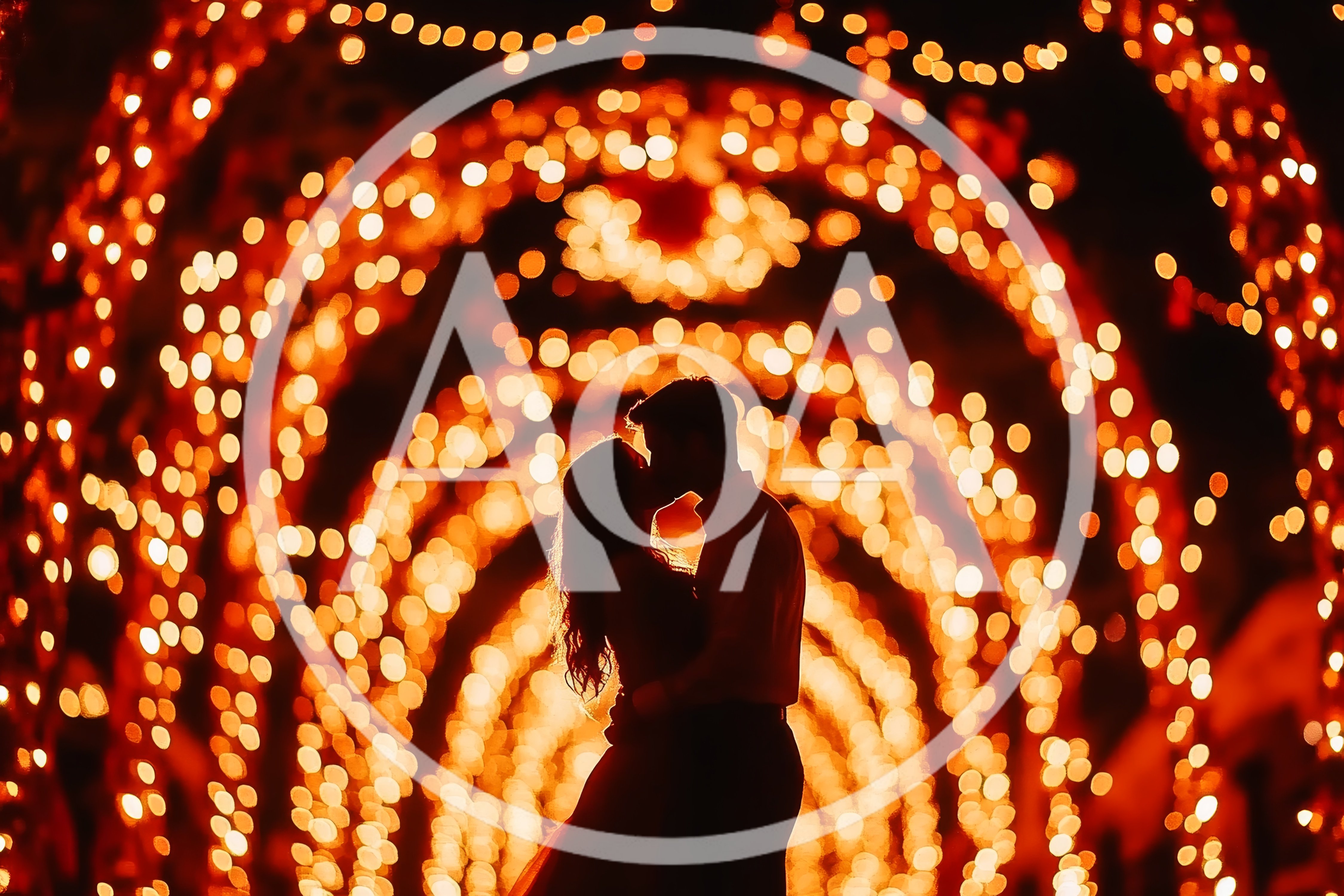 Silhouette Of A Romantic Couple Kissing Under Fairy Lights
