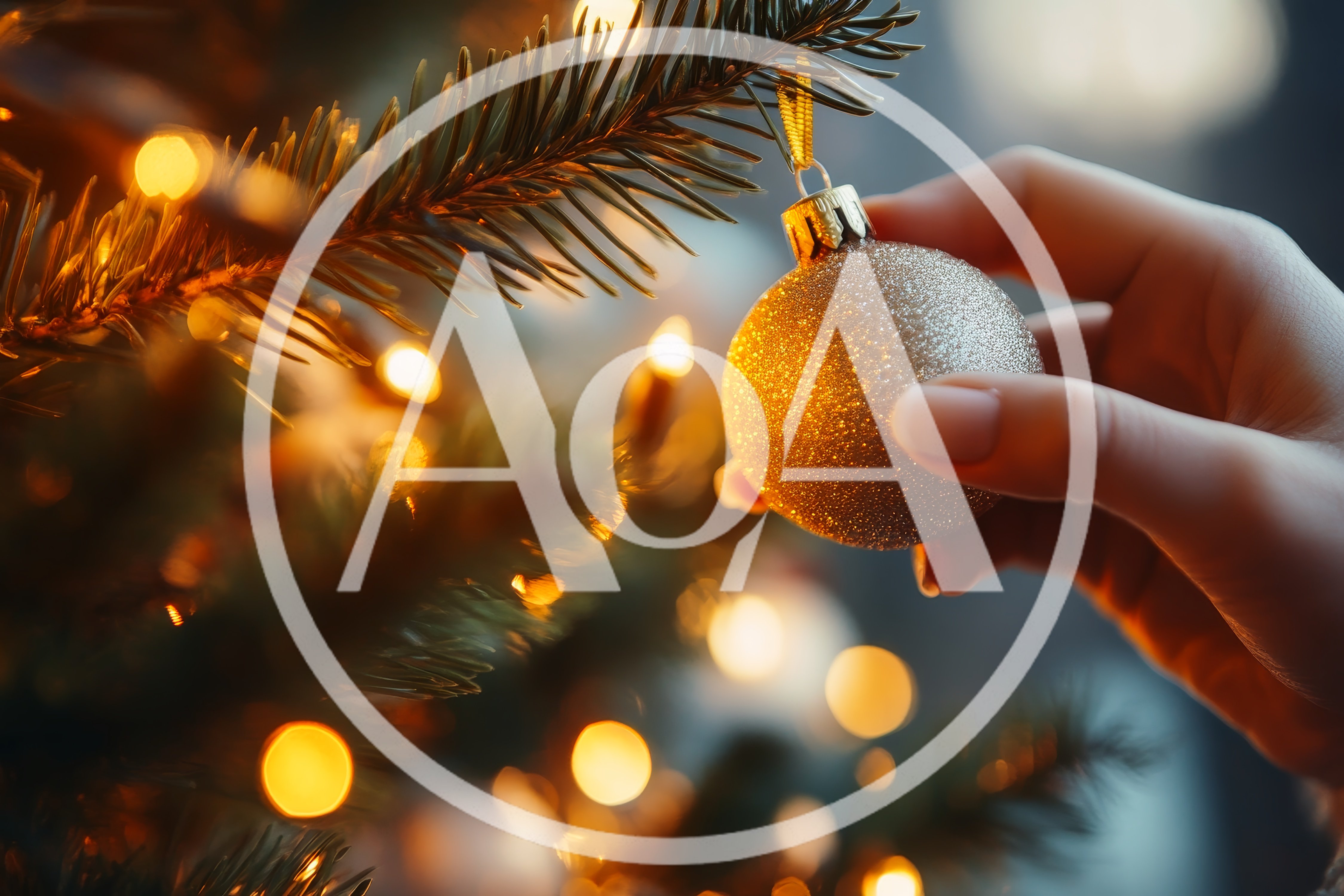 Hand Placing A Golden Ornament On A Christmas Tree