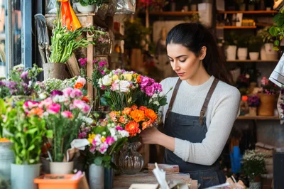 Professional Florist Arranging Flowers In A Boutique Shop