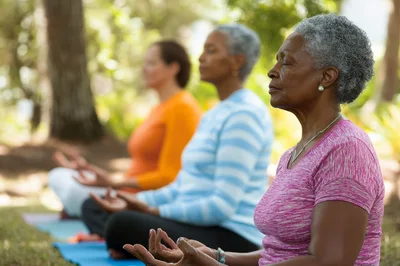 Diverse Women Practicing Meditation Outdoors