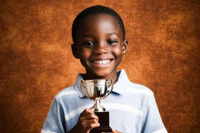 Happy Young Boy Holding A Gold Trophy