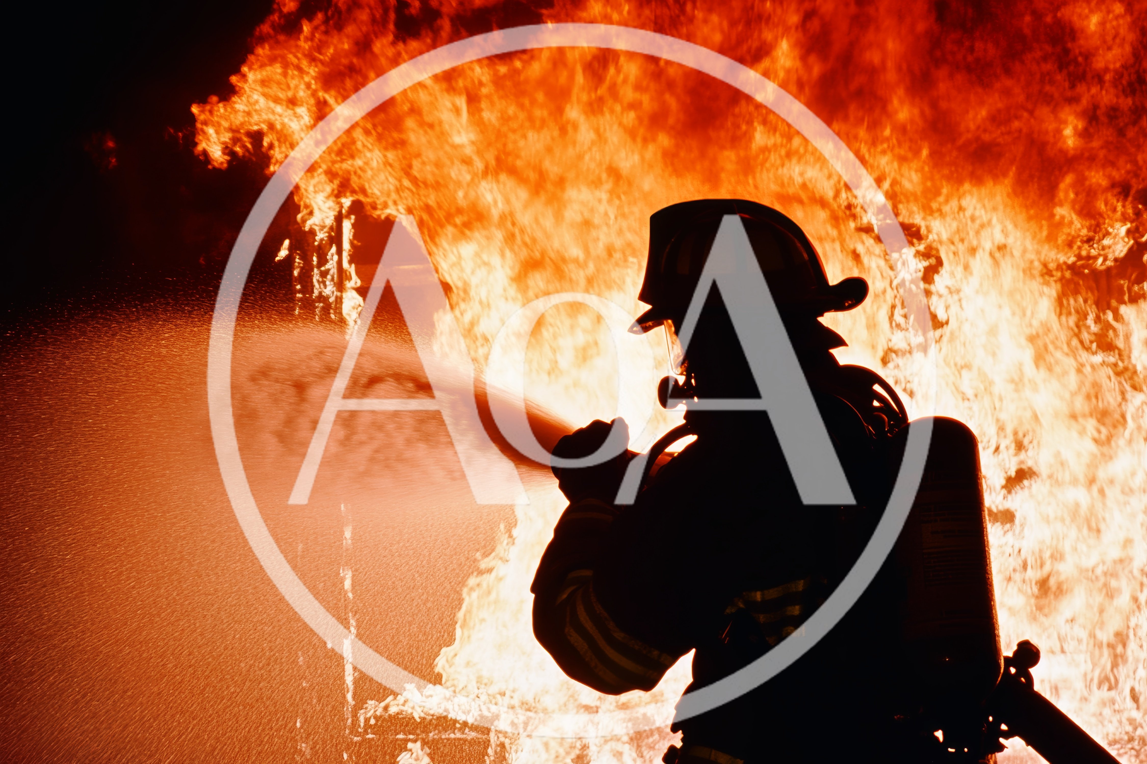 Firefighter Silhouetted Against Intense Building Fire