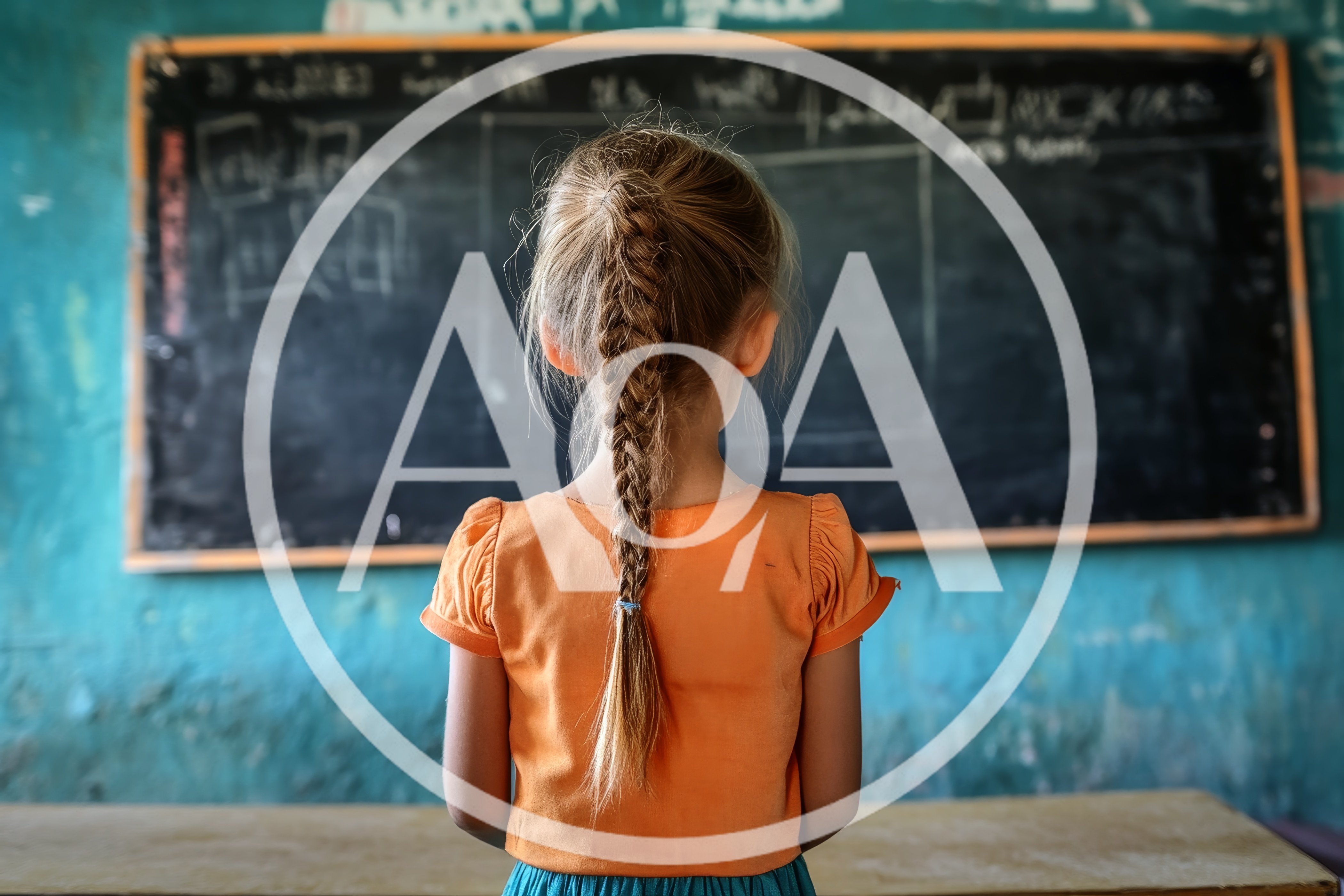 Young Girl Standing Before A Classroom Blackboard