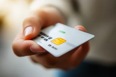 Person Holding A Credit Card For Payment
