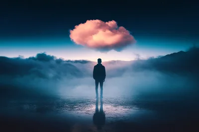 Silhouette Of A Man Standing Under A Glowing Cloud