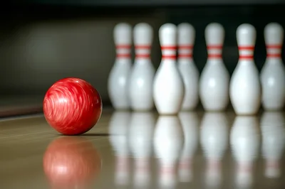 Red Bowling Ball Approaching Pins On A Lane