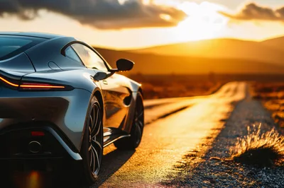 Luxury Sports Car Parked On Desert Road At Sunset