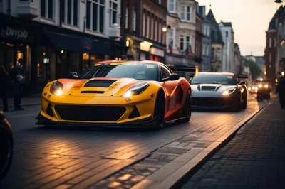 Two Sports Cars Driving Down A European City Street