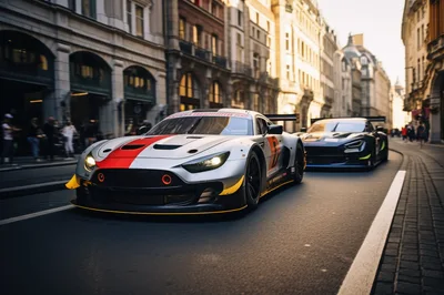 Two Racing Cars Driving Through A European City Street