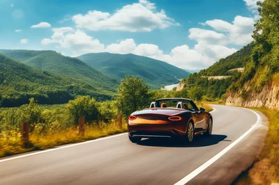 Convertible Sports Car Driving Along Scenic Mountain Road