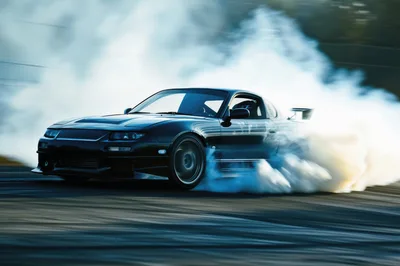 Black Sports Car Drifting With Tire Smoke