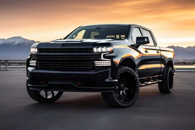 Black Pickup Truck Parked Against Sunset Mountain Backdrop