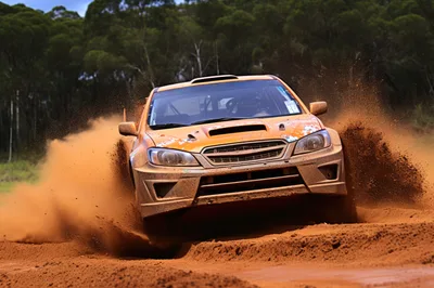 Orange Rally Car Drifting Through Dirt Track
