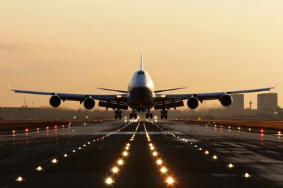 Boeing 747 Landing On Airport Runway At Sunset