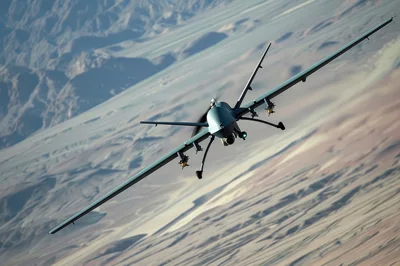 Military Unmanned Aerial Vehicle Flying Over Desert Landscape